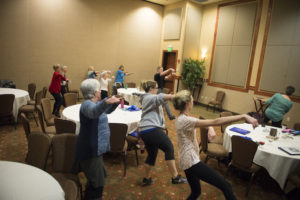 People learning a dance at the Group of people in workout clothing prepping to workout