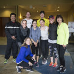 Group of people in workout gear smiling