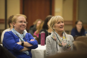 people listening intently to the speaker at the wellness conference