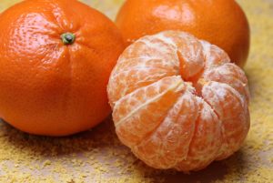 2 tangerines and 1 peeled tangerine