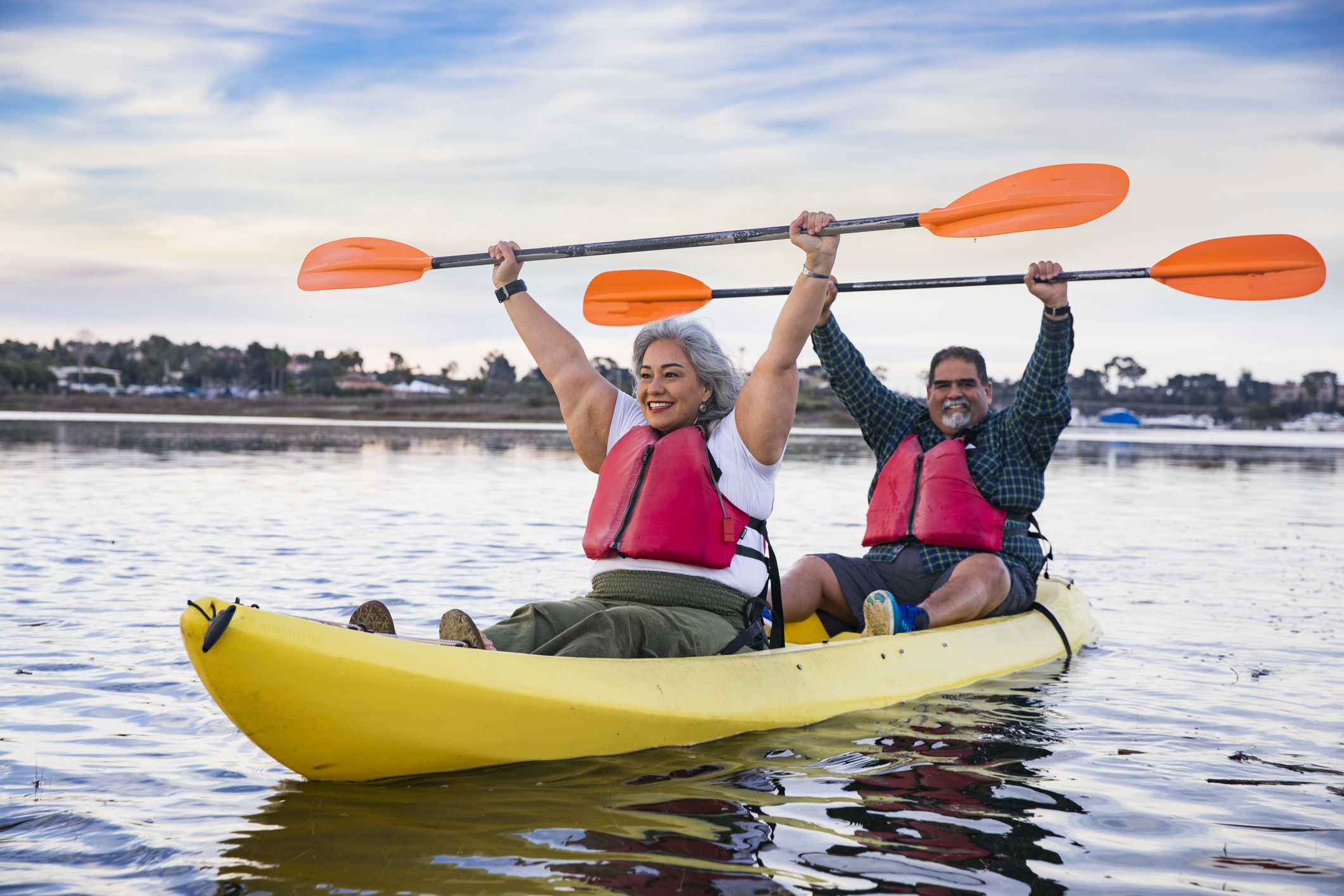two people in a yellow kayak smiling