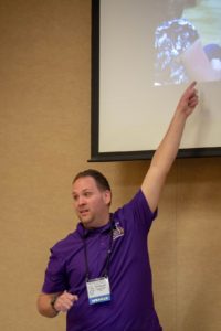 Person in a purple shirt pointing to their presentation