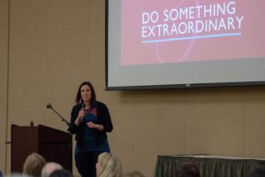 Person giving a presentation on Do Something Extraordinary