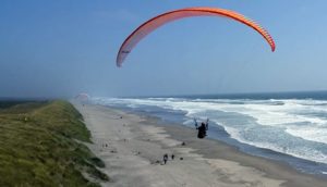 Person parasailing on the coast of Astoria, Oregon