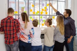 Group of people share ideas on Post-Its